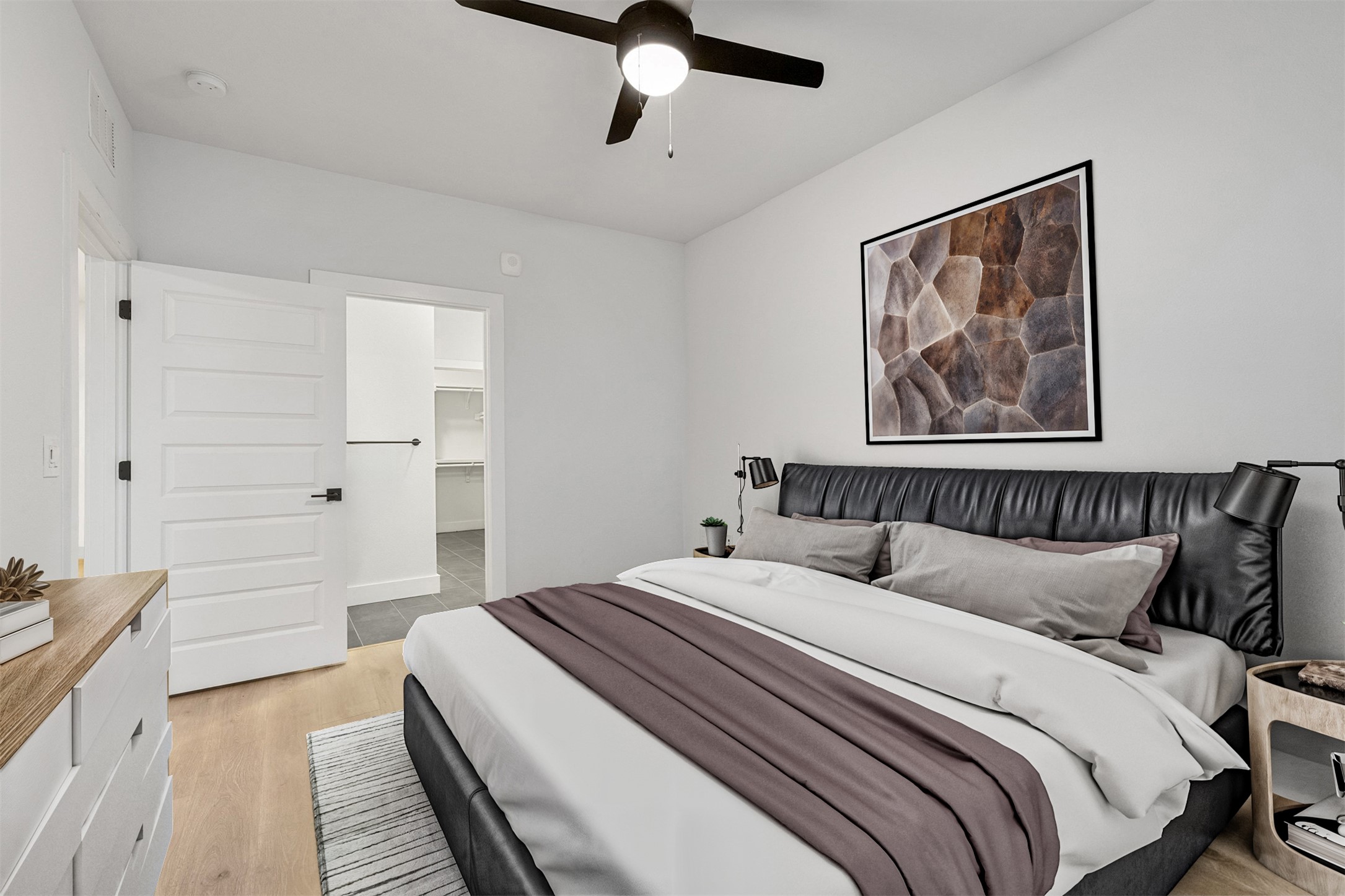 2500 Longview Street, Unit 418 Austin, TX 78705 - Photo 16 of 40 Bedroom with a spacious closet, light wood-type flooring, and ceiling fan