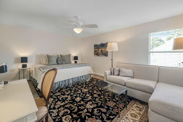 a bedroom with a bed and a couch