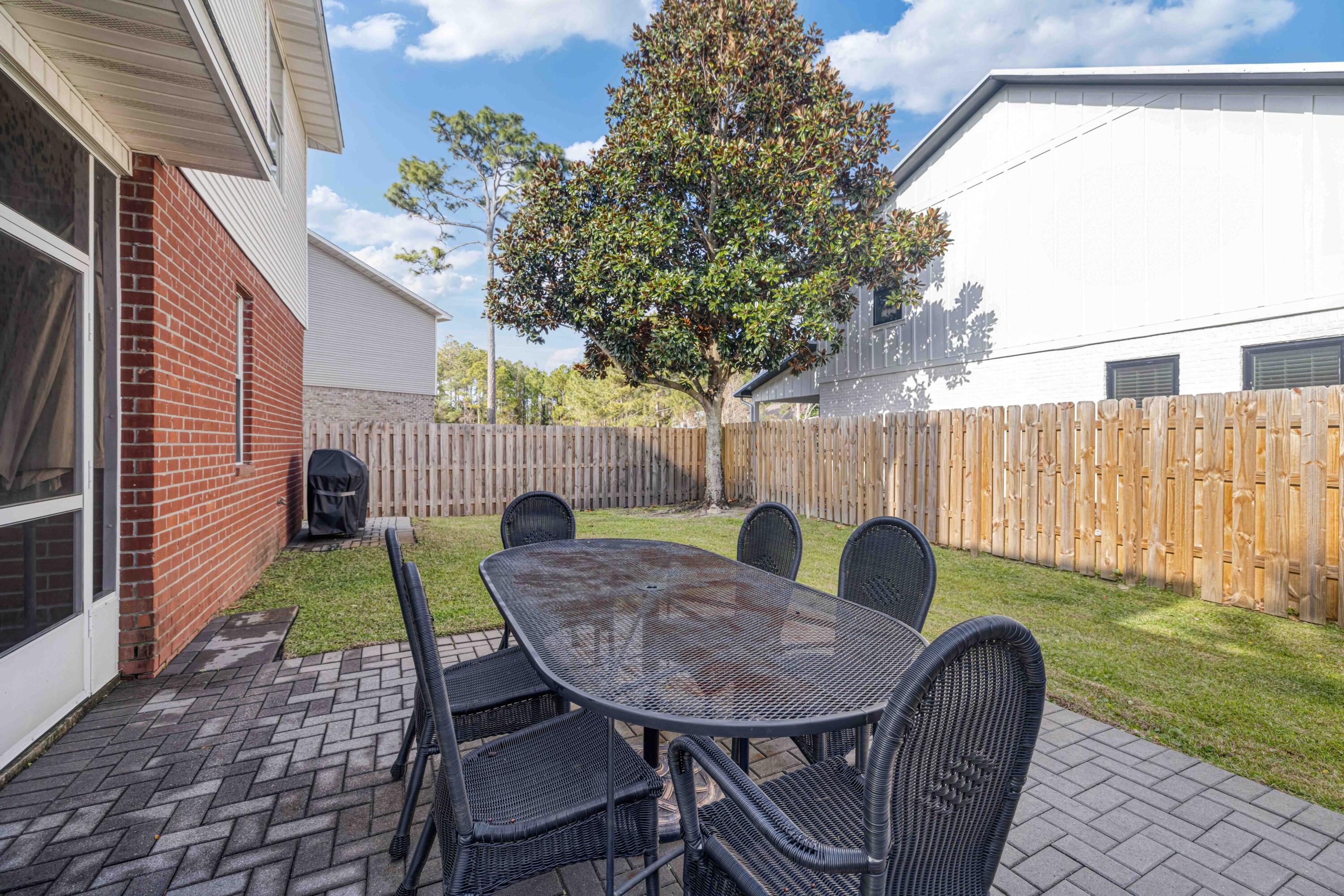 31 Corte Lago Santa Rosa Beach, FL 32459 - Photo 20 of 25 a view of backyard with table and chairs and wooden fence