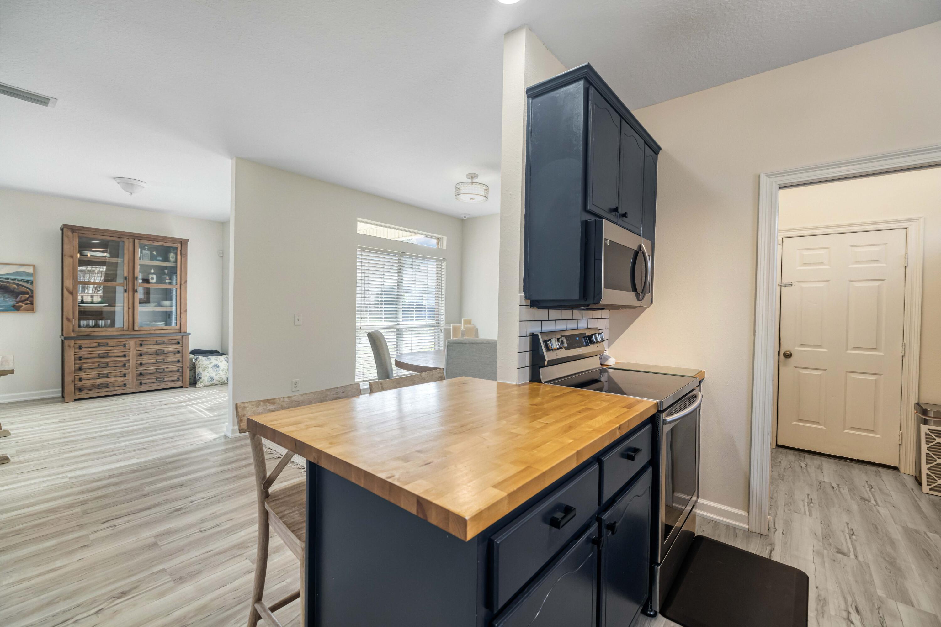 31 Corte Lago Santa Rosa Beach, FL 32459 - Photo 7 of 25 a kitchen with kitchen island a sink appliances and wooden floor