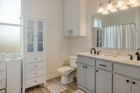 a bathroom with a toilet sink and mirror