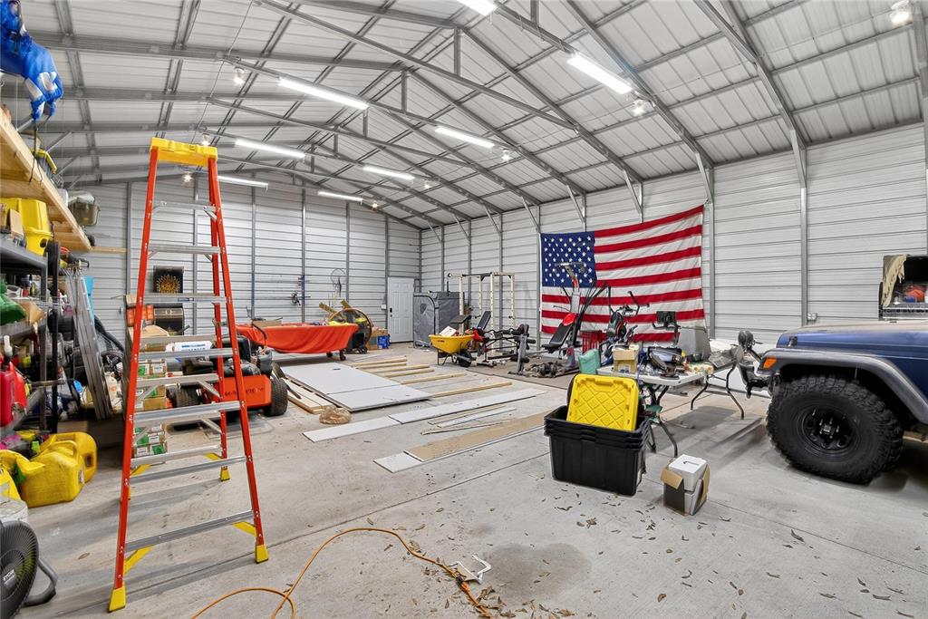 3309 Timberlee Road Wimauma, FL 33598 - Photo 36 of 56 a view of a patio with table and chairs and potted plants