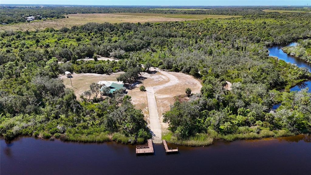 3309 Timberlee Road Wimauma, FL 33598 - Photo 49 of 56 an aerial view of a house with a yard and lake view
