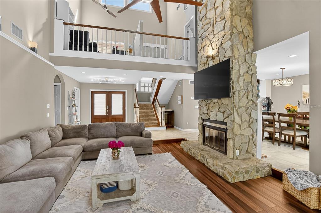 3309 Timberlee Road Wimauma, FL 33598 - Photo 8 of 56 a living room with furniture a fireplace and a flat screen tv