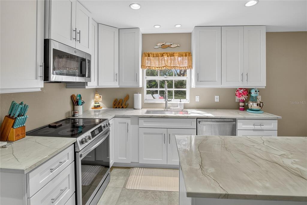 3309 Timberlee Road Wimauma, FL 33598 - Photo 10 of 56 a kitchen with granite countertop a sink stove and cabinets