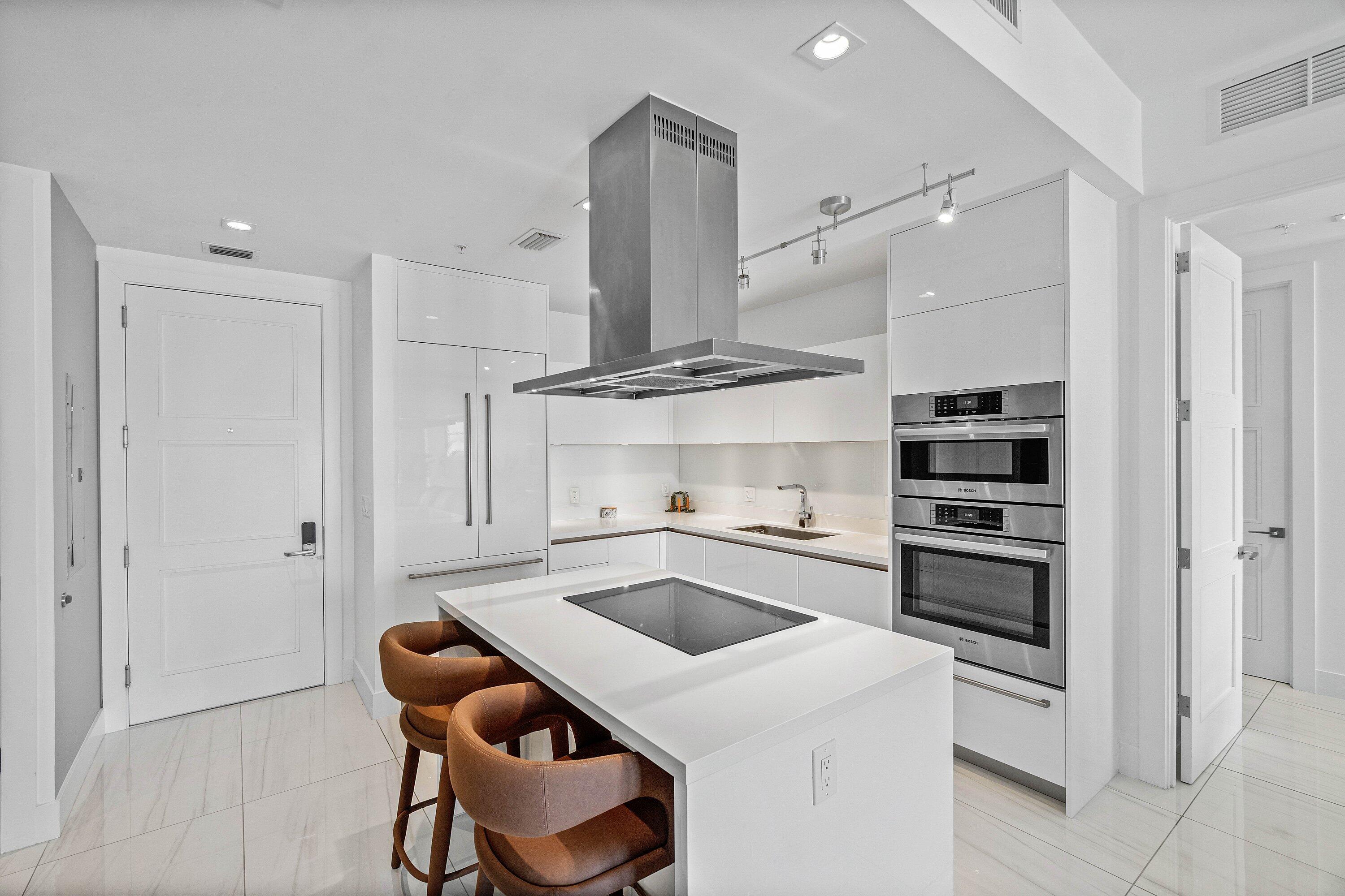 155 East Boca Raton Road, Unit 1119 Boca Raton, FL 33432 - Photo 6 of 41 a kitchen that has a sink and a stove in it