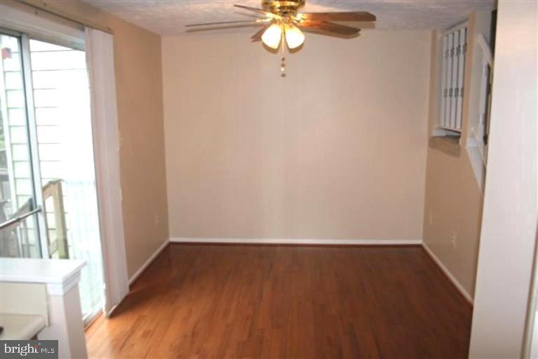 15081 Mill Spring Drive Dumfries, VA 22025 - Photo 11 of 13 wooden floor in an empty room with a window