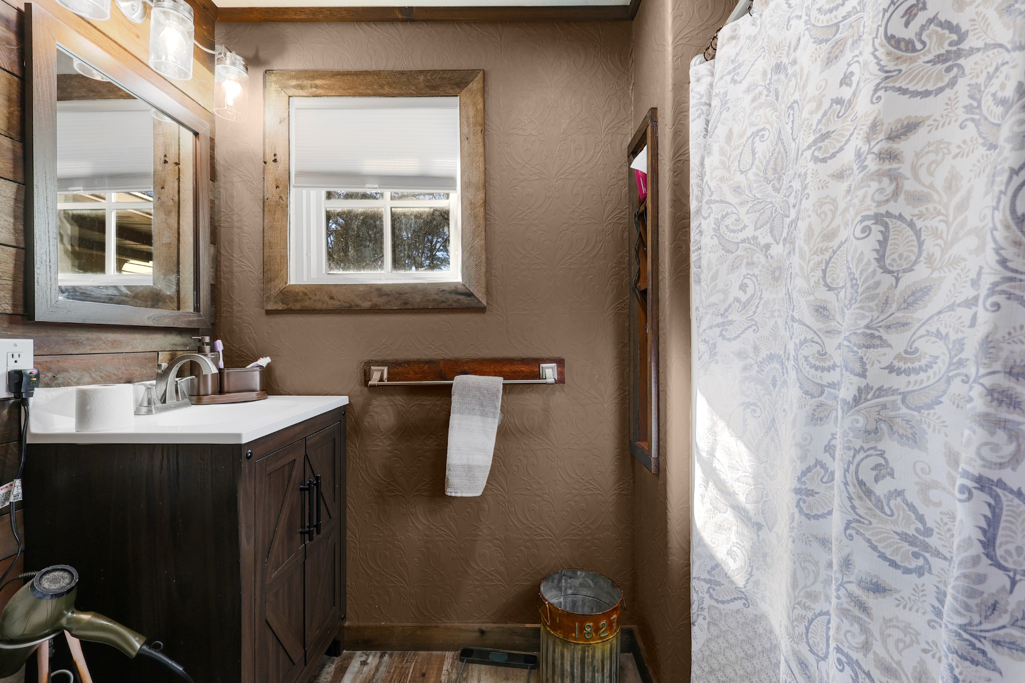 80 Woody Lane Springville, TN 38256 - Photo 15 of 31 a bathroom with a sink and mirror with toilet