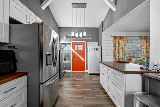 a kitchen with stainless steel appliances a refrigerator and a sink