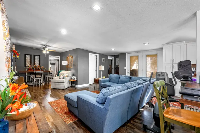 a living room with furniture and a wooden floor