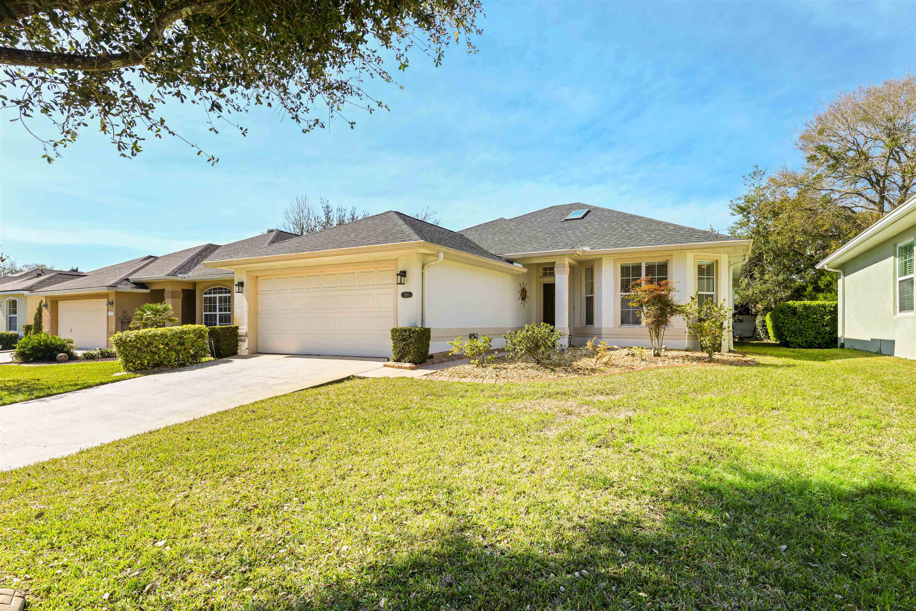 a front view of a house with yard and patio