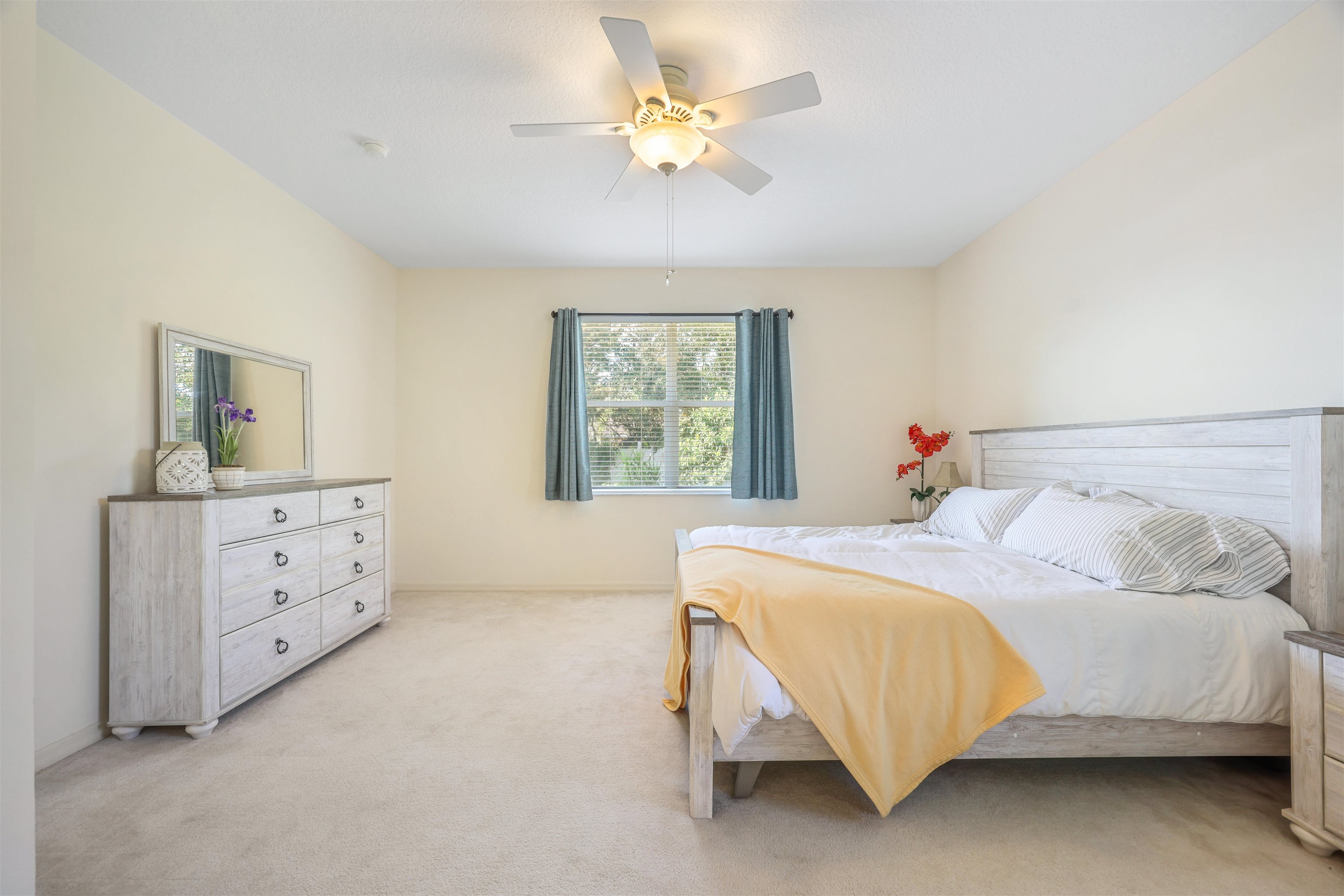 1017 Ridgewood Lane St. Augustine, FL 32086 - Photo 19 of 43 a bedroom with a bed and a chandelier fan