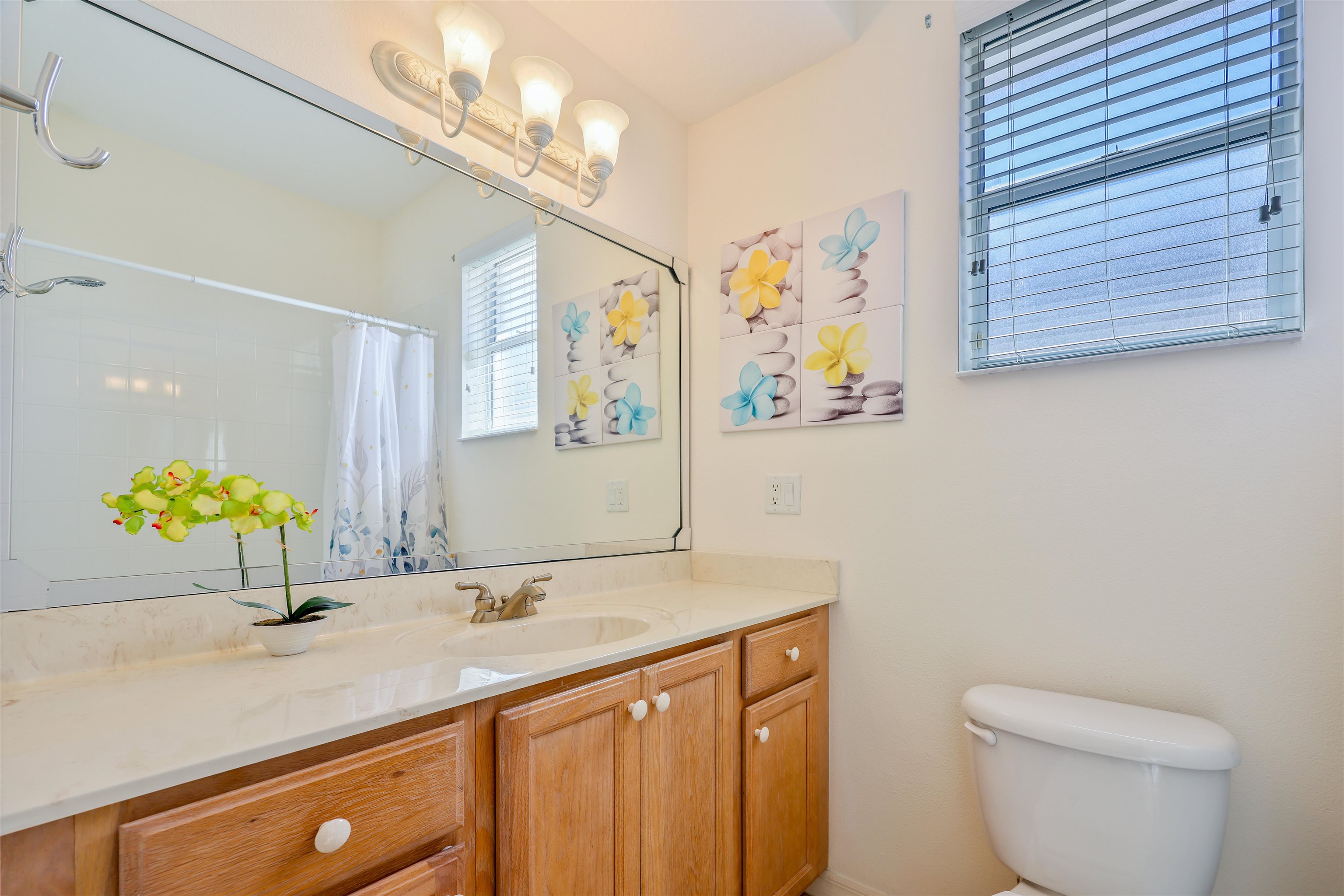 1017 Ridgewood Lane St. Augustine, FL 32086 - Photo 28 of 43 a bathroom with a granite countertop sink a toilet and a mirror