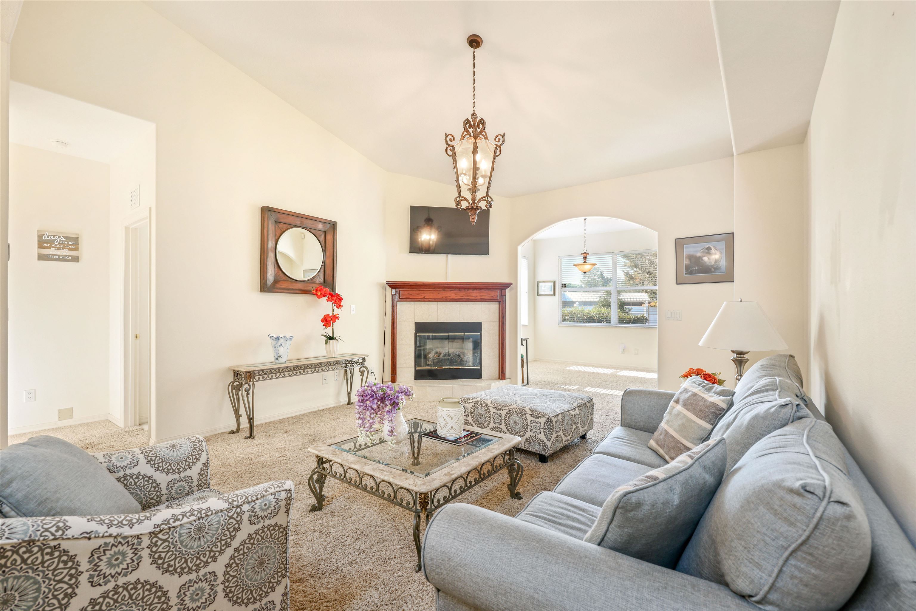 1017 Ridgewood Lane St. Augustine, FL 32086 - Photo 5 of 43 a living room with furniture a fireplace and a chandelier