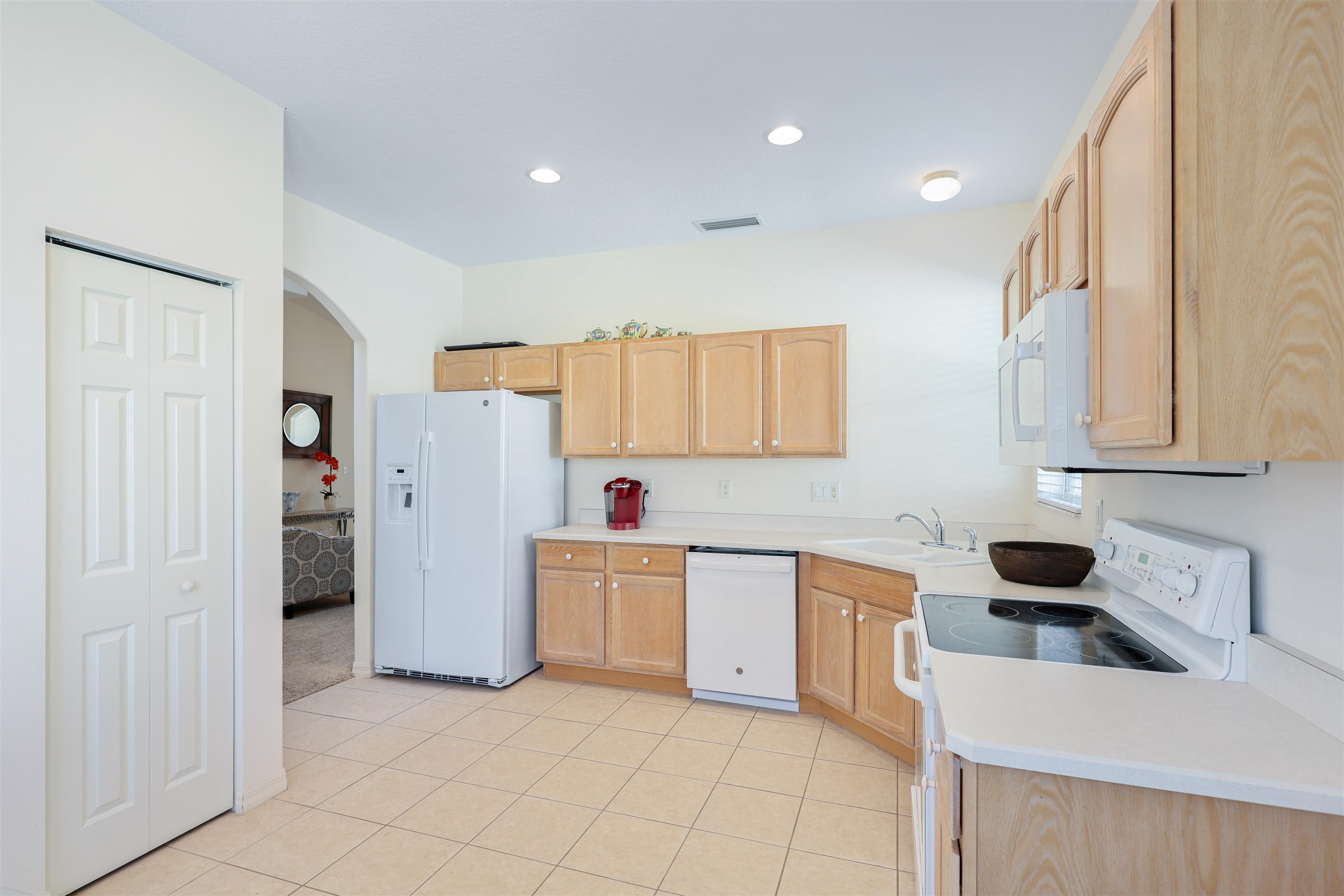 1017 Ridgewood Lane St. Augustine, FL 32086 - Photo 9 of 43 a kitchen with stainless steel appliances a refrigerator sink and cabinets