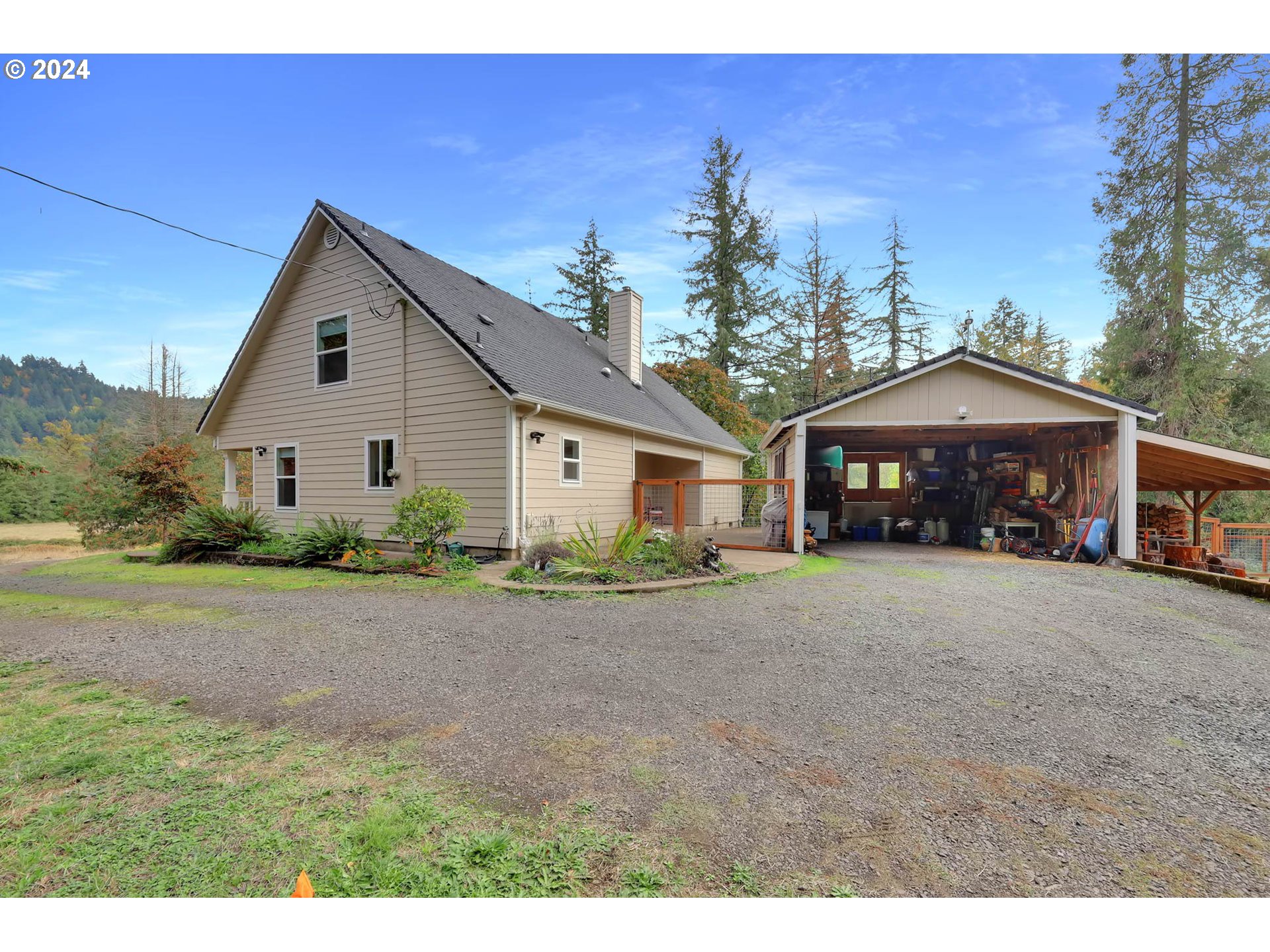 40089 Little Fall Creek Road Fall Creek, OR 97438 - Photo 3 of 40 a front view of a house with a yard and garage