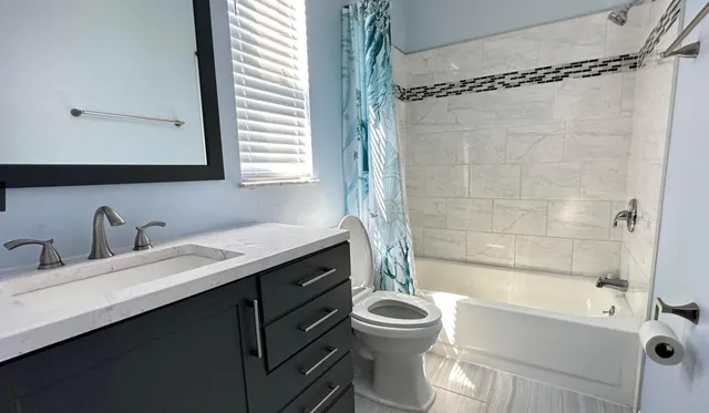 a bathroom with a sink a toilet and a bathtub