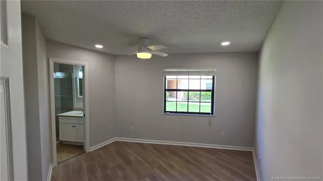 an empty room with windows and closet