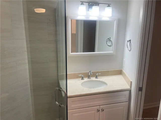 a bathroom with a sink vanity and a mirror