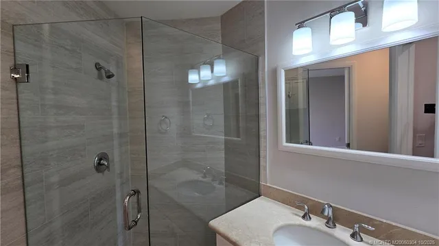 a bathroom with a shower and a sink
