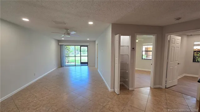 a view of a hallway with wooden floor and glass door