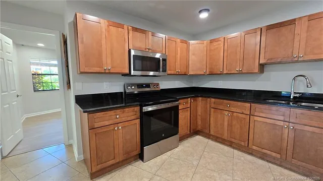 a kitchen with stainless steel appliances granite countertop a sink and cabinets