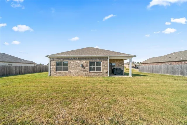 a view of a backyard with table and chairs