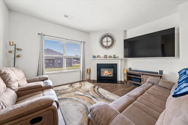 a view of a livingroom with furniture and a flat screen tv