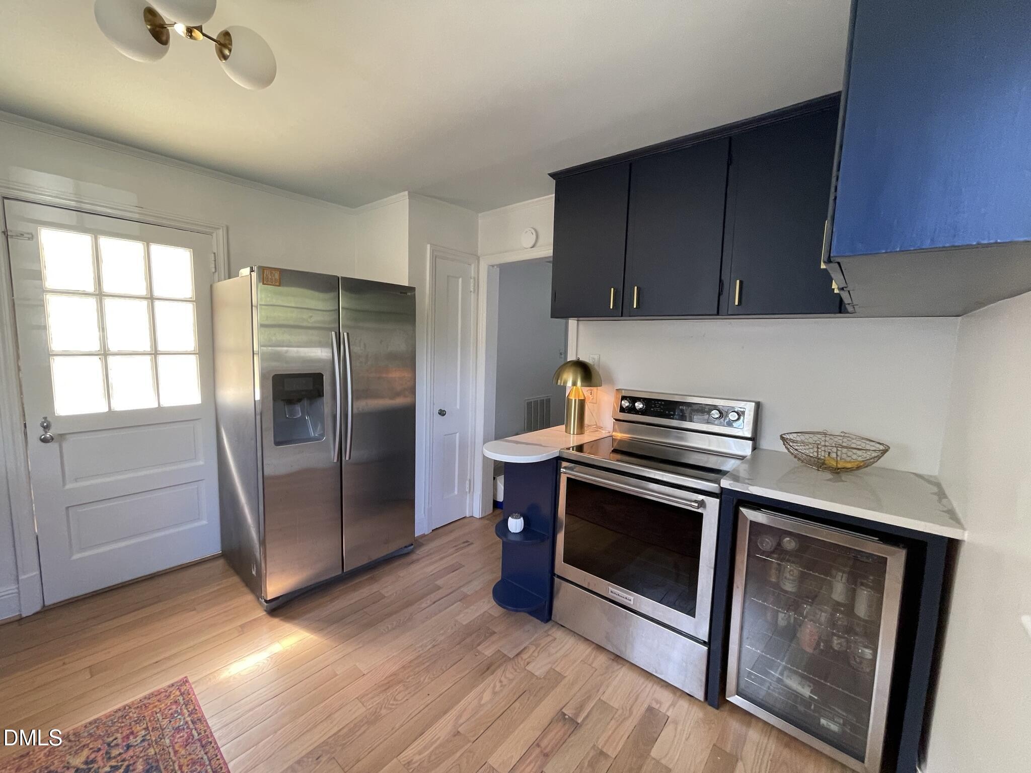 1009 Canterbury Road Raleigh, NC 27607 - Photo 25 of 31 a kitchen with a refrigerator stove and cabinets