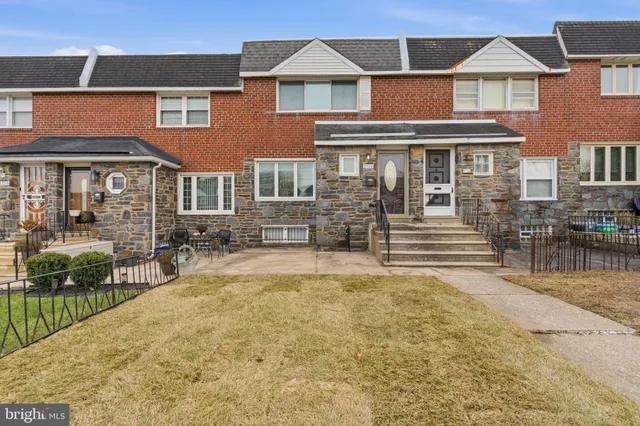 a front view of a residential apartment building with a yard