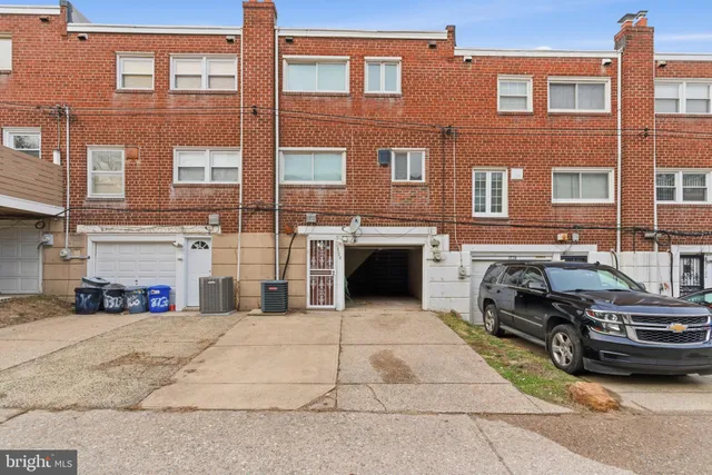 a car parked in front of a brick building