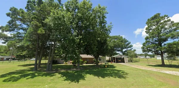 a front view of a house with a yard garage and outdoor seating