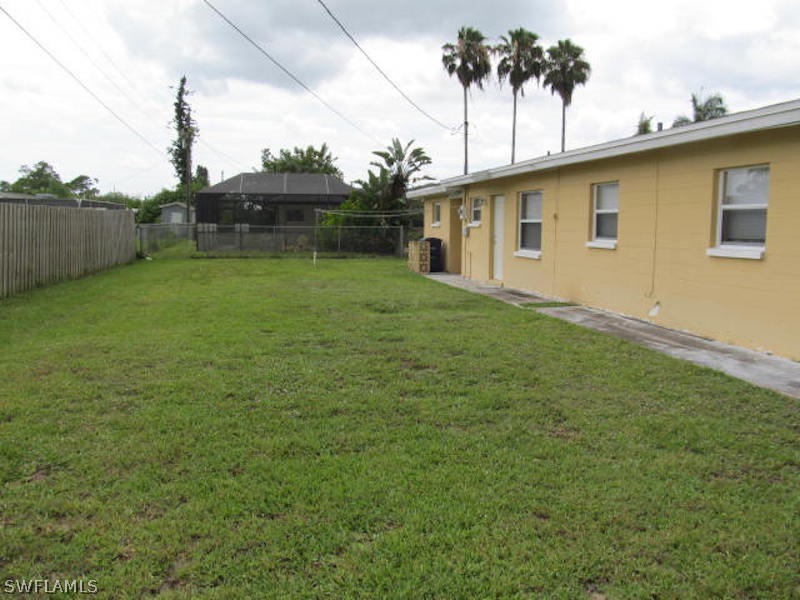 308 East Penn Road Lehigh Acres, FL 33936 - Photo 13 of 15 a backyard of a house with table and chairs