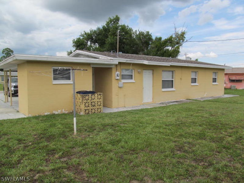 308 East Penn Road Lehigh Acres, FL 33936 - Photo 14 of 15 a view of a house with a yard