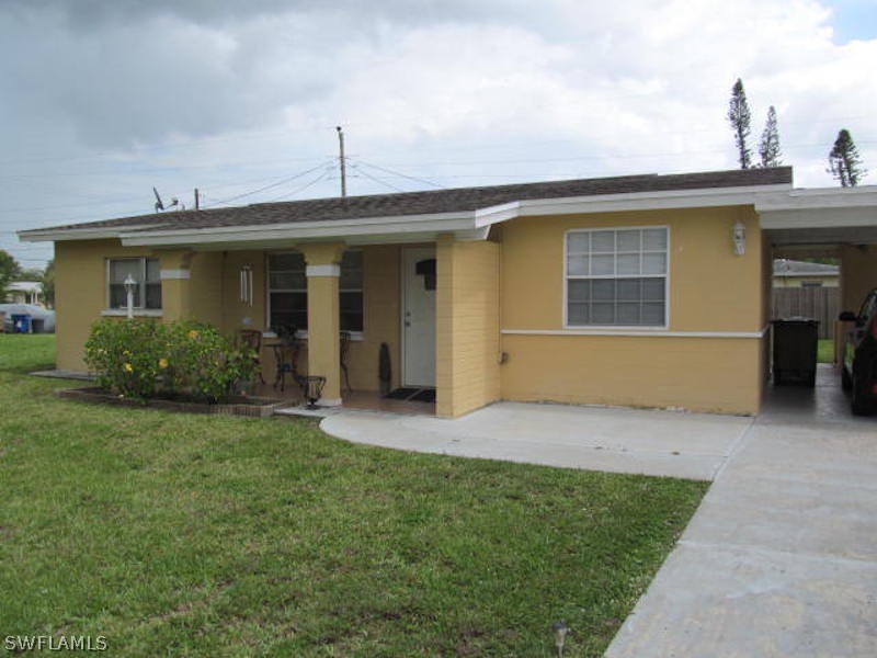 308 East Penn Road Lehigh Acres, FL 33936 - Photo 2 of 15 a view of a house with a yard