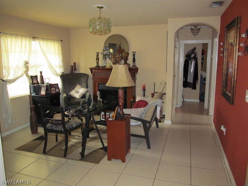 308 East Penn Road Lehigh Acres, FL 33936 - Photo 3 of 15 a dining room with furniture and a chandelier