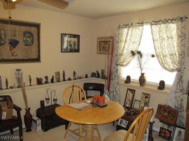 308 East Penn Road Lehigh Acres, FL 33936 - Photo 5 of 15 a view of a dining room with furniture and chandelier