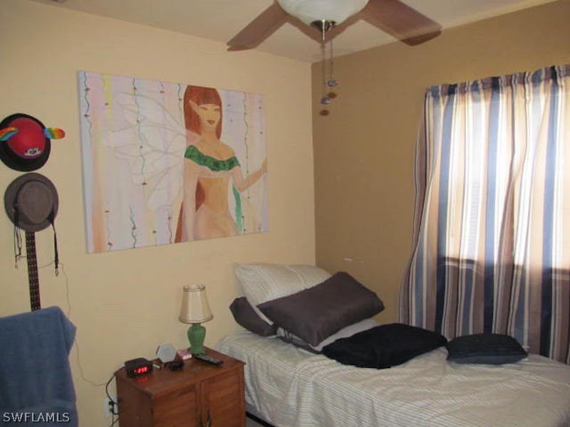 308 East Penn Road Lehigh Acres, FL 33936 - Photo 10 of 15 a bedroom with a bed and a window