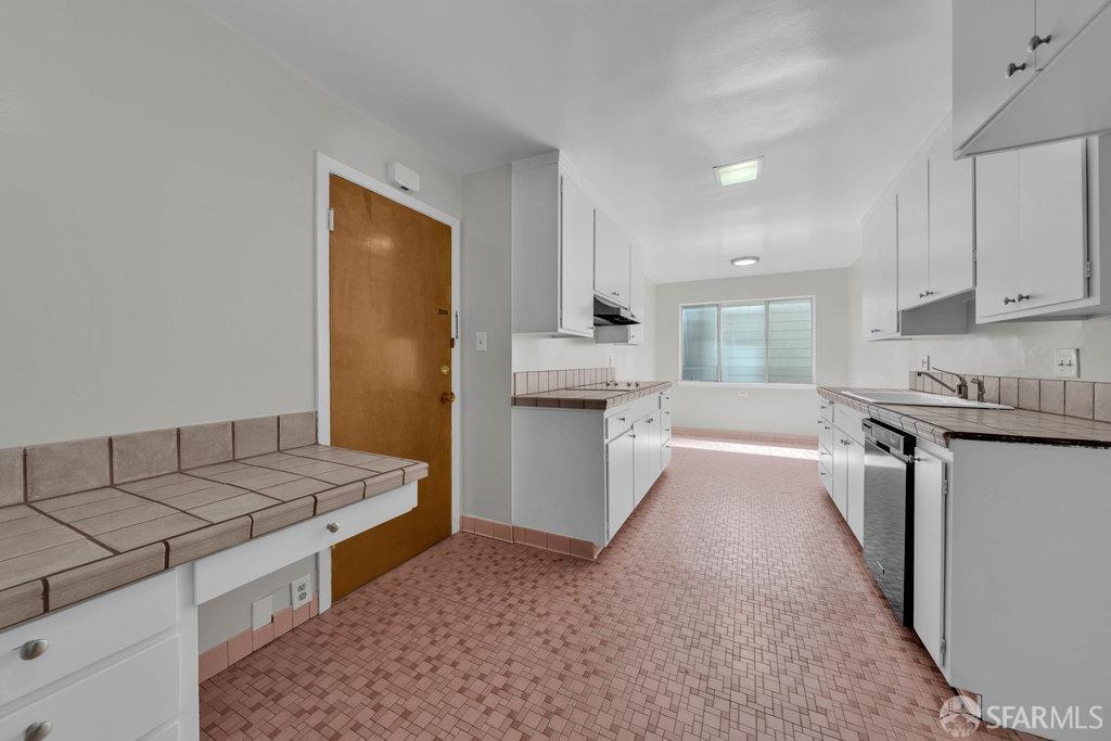 1401 Walnut Street, Unit 1B Berkeley, CA 94709 - Photo 20 of 53 a large kitchen with a stove a sink dishwasher and a refrigerator with white cabinets