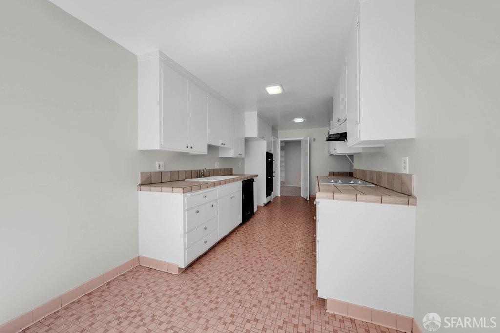 1401 Walnut Street, Unit 1B Berkeley, CA 94709 - Photo 23 of 53 a kitchen with a refrigerator sink and cabinets