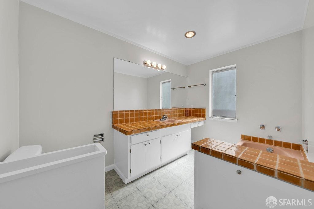 1401 Walnut Street, Unit 1B Berkeley, CA 94709 - Photo 29 of 53 a bathroom with a sink and a mirror