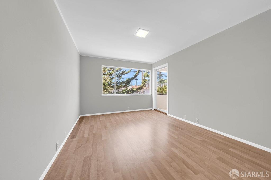 1401 Walnut Street, Unit 1B Berkeley, CA 94709 - Photo 32 of 53 an empty room with wooden floor and window