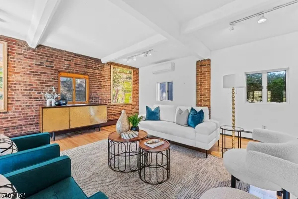 a living room with furniture and a floor to ceiling window