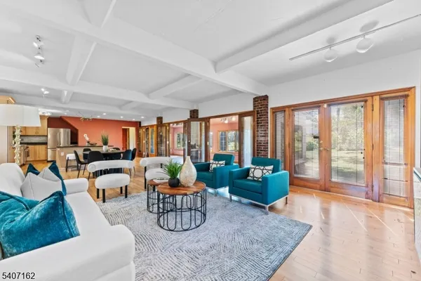 a living room with furniture fireplace and a large window