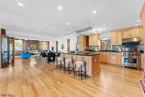 a kitchen with stainless steel appliances granite countertop a refrigerator stove microwave and sink