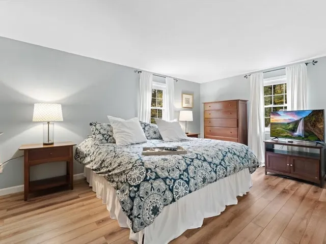a spacious bedroom with a large bed and a dresser