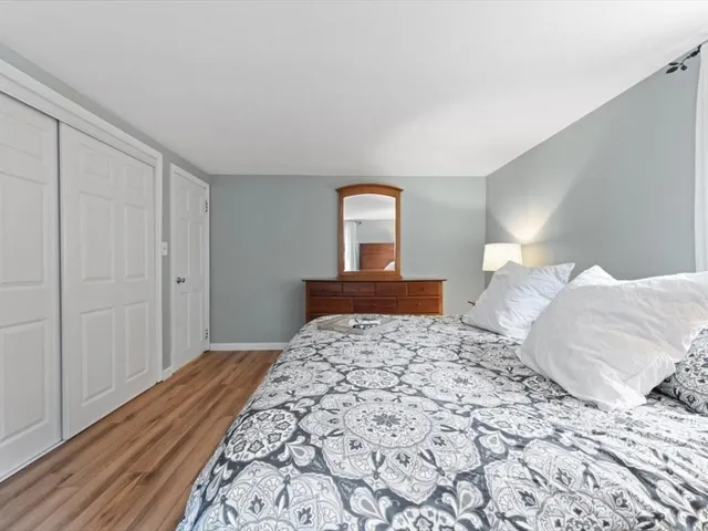 a bedroom with a bed and a lamp