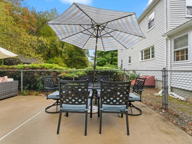 a view of an outdoor sitting area with wooden chairs