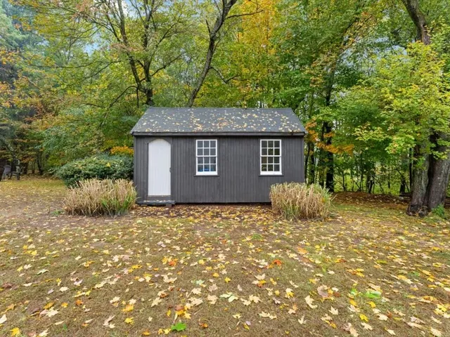 a house that has a tree in front of it