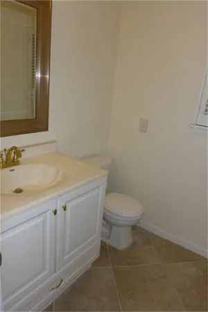 a view of a patio with table and chairs and couches with wooden fence